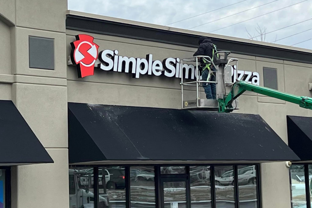 Signage is installed for Simple Simon's Pizza at Elfindale Corners.